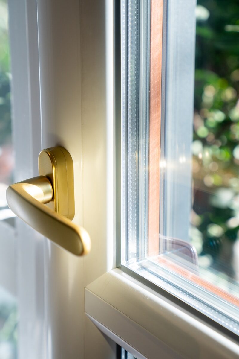 A close up of a door handle on a window